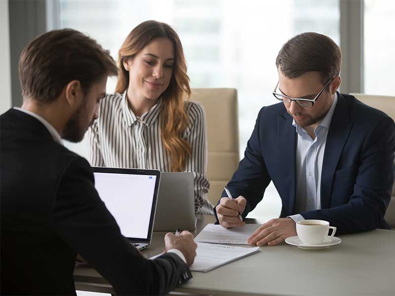 Man and woman signing a document